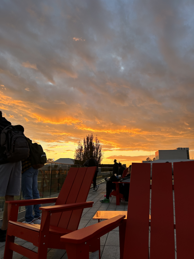 An orange and cloudy sunset taken from the Simon Fraser University (SFU) Burnaby campus Rotunda Roof.