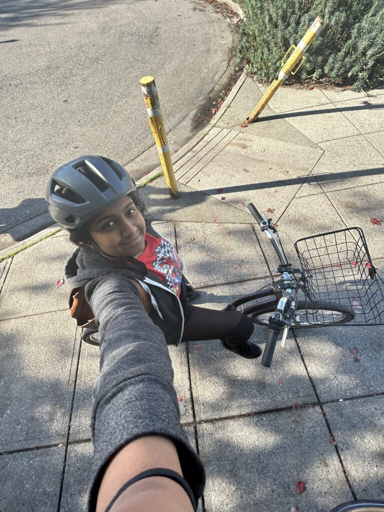 Praevalli taking a selfie on a cruiser bicycle.